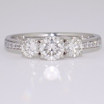 Platinum round brilliant cut diamond trilogy ring with diamond-set shoulders