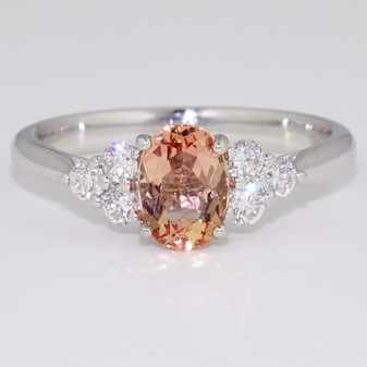 Platinum oval cut Imperial topaz and round brilliant cut diamond ring