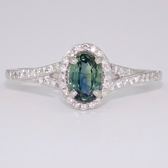 Platinum oval cut teal sapphire and round brilliant cut diamond cluster ring with split diamond-set shoulders