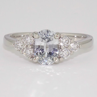 Platinum unheated oval cut Sri Lankan white sapphire and round brilliant cut diamond ring