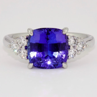 Platinum cushion cut tanzanite and six round brilliant cut diamond ring