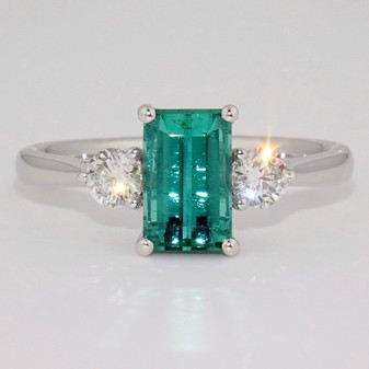 Platinum emerald cut tourmaline and round brilliant cut diamond ring