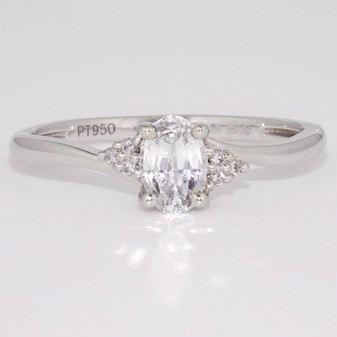 Platinum oval cut white sapphire and round brilliant cut diamond twist ring