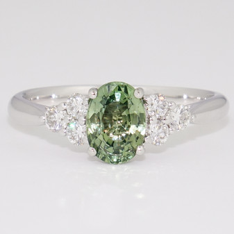 Platinum oval cut green sapphire and round brilliant cut diamond ring