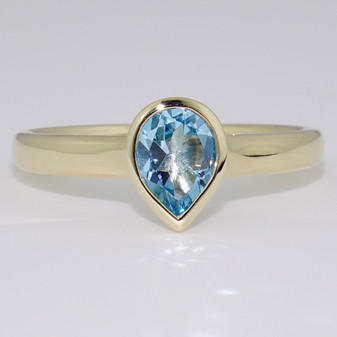 9ct gold pear cut blue topaz rubover ring