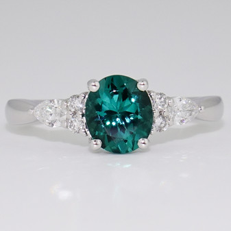 Platinum ring with fancy oval cut indicolite tourmaline and round brilliant cut and pear cut diamonds
