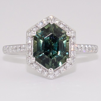 Platinum hexagon cut green sapphire and round brilliant cut diamond cluster ring with diamond-set shoulders