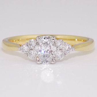 18ct gold and platinum ring with a certificated D colour oval cut diamond and six round brilliant cut diamonds