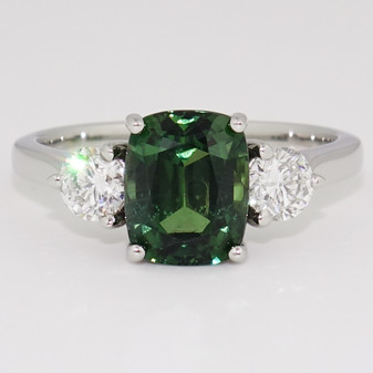 Unique rectangular cushion cut green sapphire and round brilliant cut diamond three stone ring