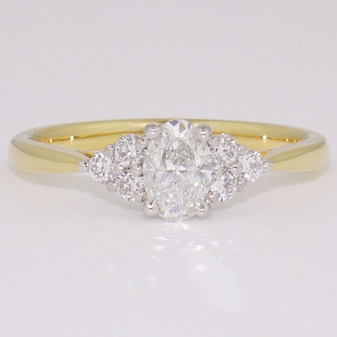 18ct gold and platinum ring with a certificated oval cut diamond and six round brilliant cut diamonds