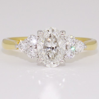 18ct gold and platinum ring with an oval cut certificated diamond and six round brilliant cut diamonds