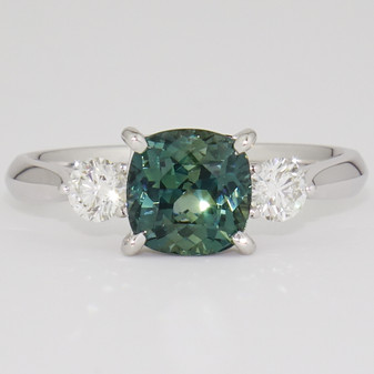 Platinum unheated cushion cut teal sapphire and round brilliant cut diamond ring