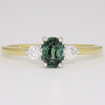 18ct gold oval cut teal sapphire and round brilliant cut diamond ring