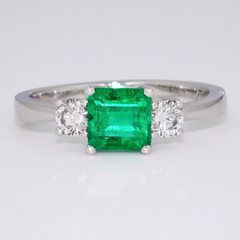 Platinum square cut emerald and round brilliant cut diamond ring