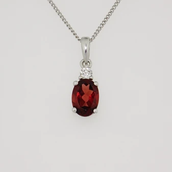 9ct white gold oval cut garnet and diamond pendant