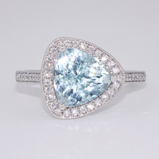 Platinum trillion cut aquamarine and diamond cluster ring with diamond-set shoulders