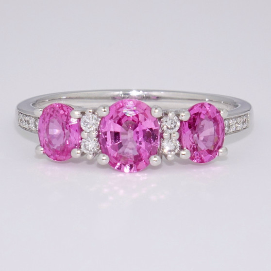 Platinum three oval cut pink sapphire and round brilliant cut diamond ring