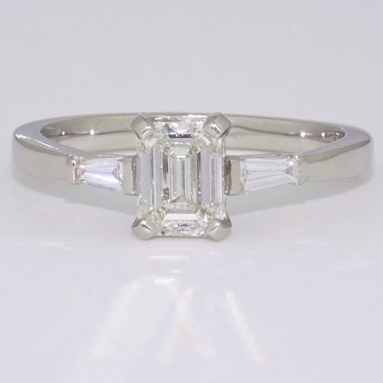 Platinum emerald cut and tapered baguette cut diamond ring