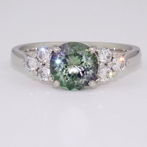 Platinum round cut green tanzanite and diamond ring