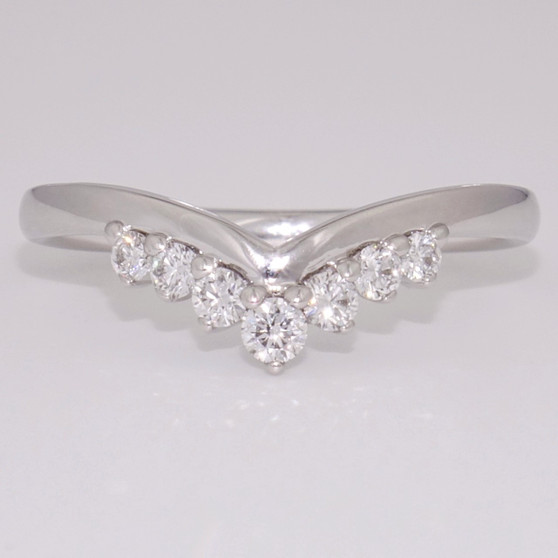 18ct white gold wishbone ring with seven round brilliant cut diamonds and a plain edge