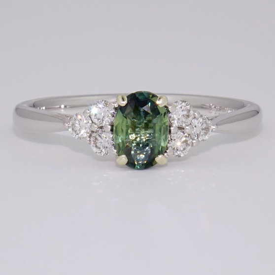 9ct white gold oval cut teal sapphire and round brilliant cut diamond ring