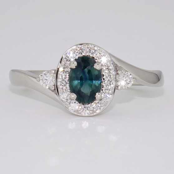 Platinum teal sapphire and diamond halo twist ring