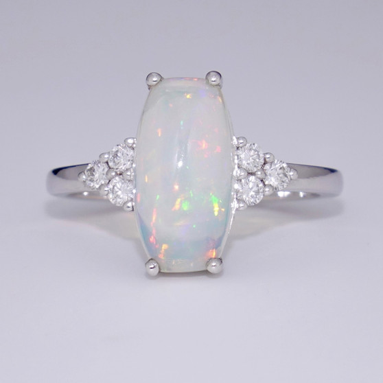 Unique 18ct white gold ring with cushion cabochon cut Ethiopian water opal and six round brilliant cut diamonds