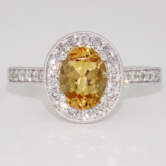 Platinum oval cut Imperial topaz and diamond halo ring with diamond-set shoulders