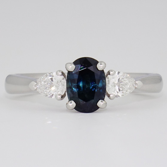Platinum oval cut teal sapphire and pear cut diamond ring