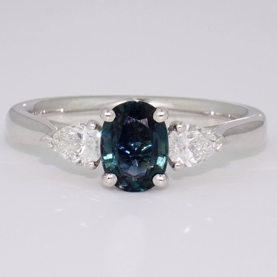 Platinum oval cut teal sapphire and pear cut diamond ring