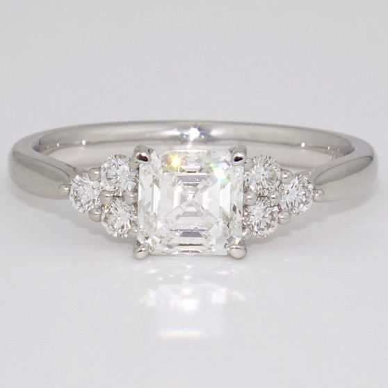 Platinum ring with an asscher cut diamond set with six round brilliant cut diamonds