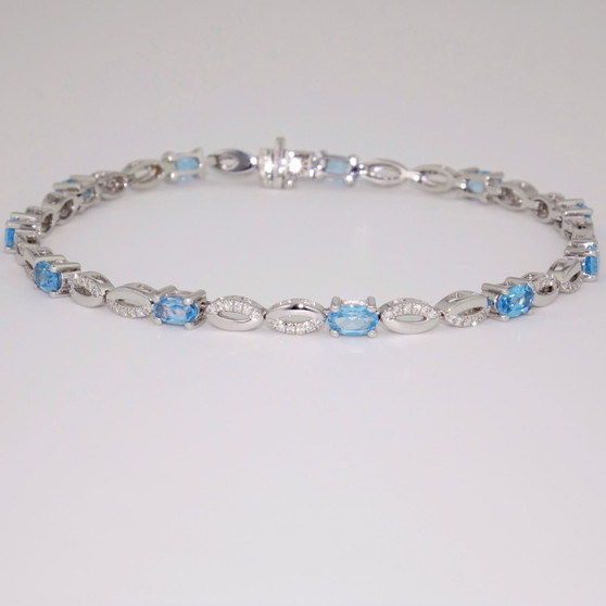 9ct white gold oval cut blue topaz and diamond-set figure-of-eight link bracelet