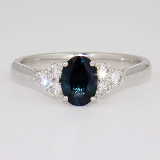 Platinum oval cut teal sapphire and round brilliant cut diamond ring