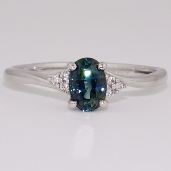 9ct white gold oval cut teal sapphire and round brilliant cut diamond twist ring