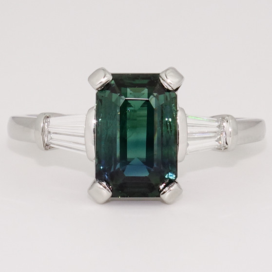 Platinum emerald cut teal sapphire and tapered baguette diamond ring