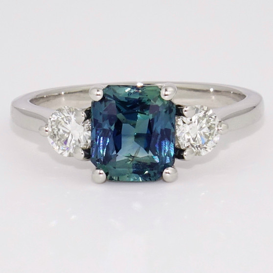 Platinum unheated radiant cut teal sapphire and round brilliant cut diamond ring
