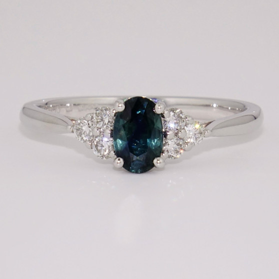 Platinum oval cut teal sapphire and round brilliant cut diamond ring