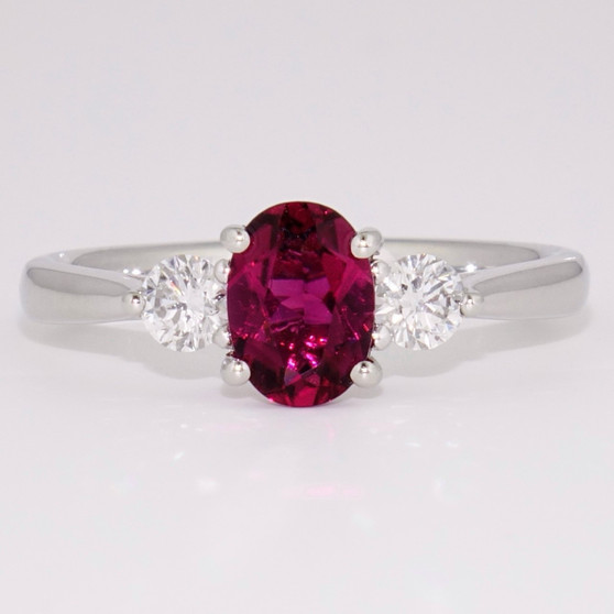 Platinum oval cut pink tourmaline and round brilliant cut diamond ring