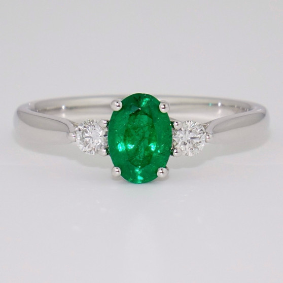 18ct white gold oval cut emerald and round brilliant cut diamond ring