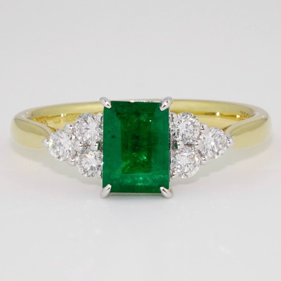 18ct gold emerald cut emerald and six round brilliant cut diamond ring