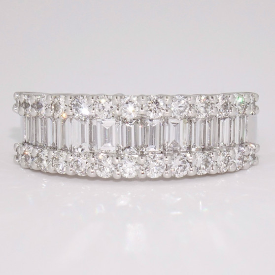 Platinum ring with a row of baguette cut diamonds between two rows of round brilliant cut diamonds