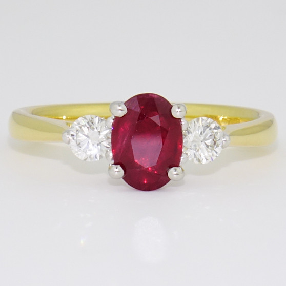 18ct gold and platinum oval cut ruby and round brilliant cut diamond ring