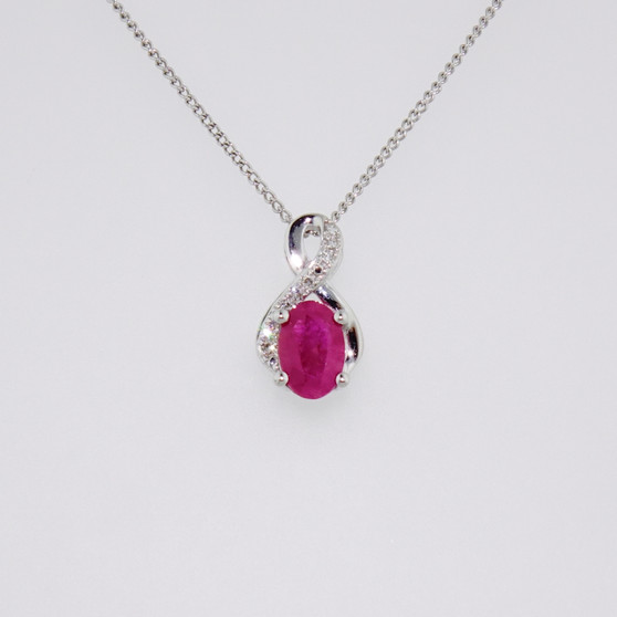 9ct white gold oval cut ruby and diamond swirl pendant
