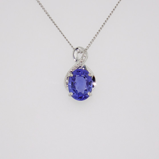 9ct white gold oval cut Ceylon sapphire and diamond swirl pendant 9ct white gold oval cut Ceylon sapphire and diamond swirl pendant