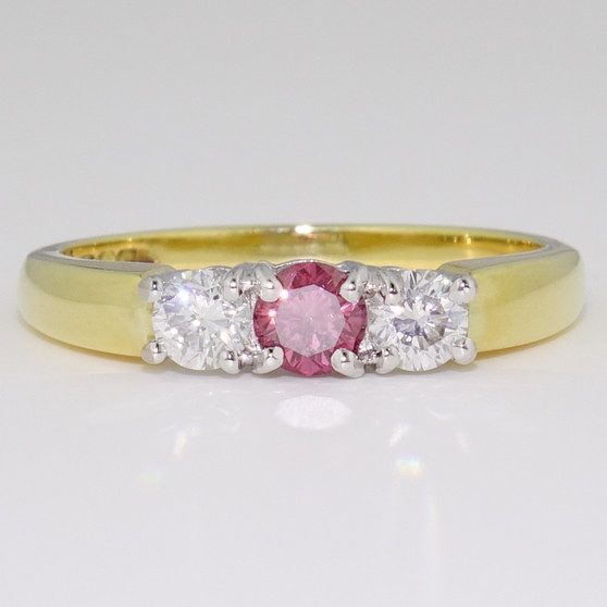 18ct yellow and white gold diamond trilogy ring with treated fancy deep purplish pink centre diamond