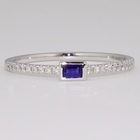 Platinum rubover-set sapphire ring with diamond-set shoulders