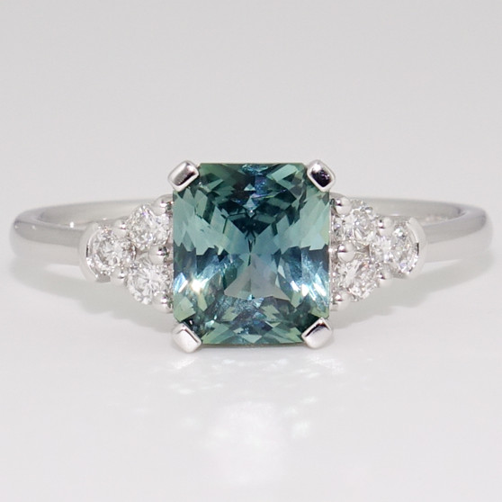 Platinum unheated radiant cut teal sapphire and round brilliant cut diamond ring