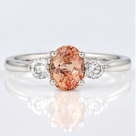 Platinum oval cut Imperial topaz and round brilliant cut diamond ring