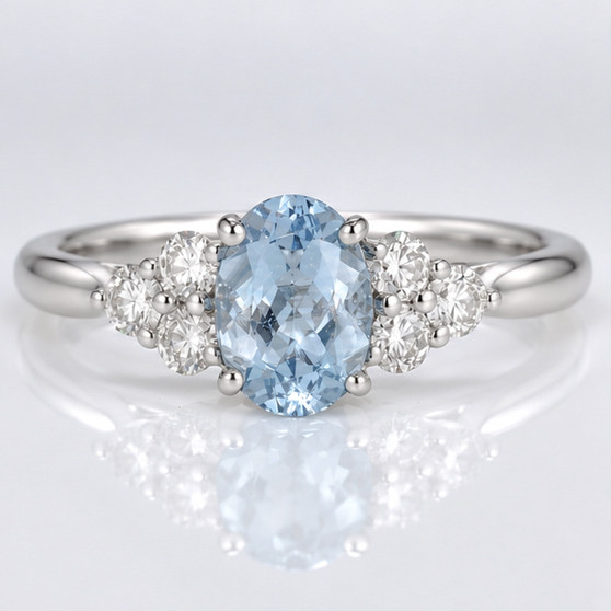 Platinum oval cut aquamarine and round brilliant cut diamond ring