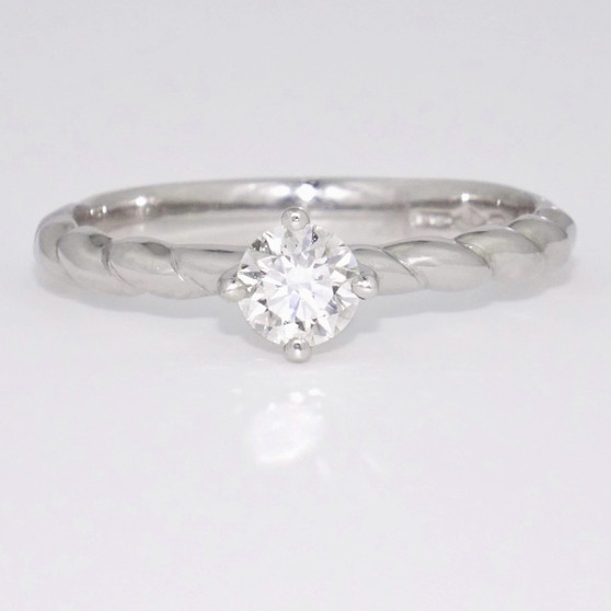 Platinum diamond solitaire ring with twisted band